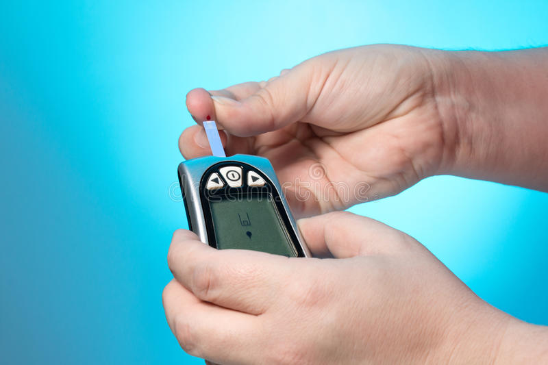 Blood Glucose Meter To Check The Blood Sugar Level Stock Photo